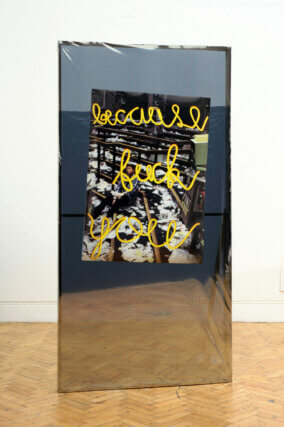 David Raymond Conroy, Broadway Flat (Because Fuck You), installation view at Camden Arts Centre, 2015. Wood, privacy film, sandbags, magnets, inkjet print, wide format print, 240 × 110 × 80cm. Courtesy the artist and Camden Arts Centre