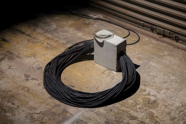 Yuko Mohri, Voluta 2017—18.
Cables, concrete, magnet, lens. Installation view at MOT Satelite, 2017. Courtesy the artist. Photo: Haruyuki Shirai