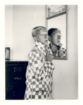 Claude Cahun Self portrait (reflected image in mirror, chequered jacket), 1928.
